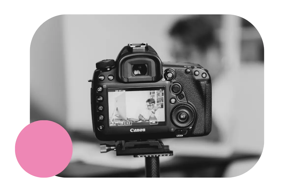 Black and white image of a camera set up on a tripod